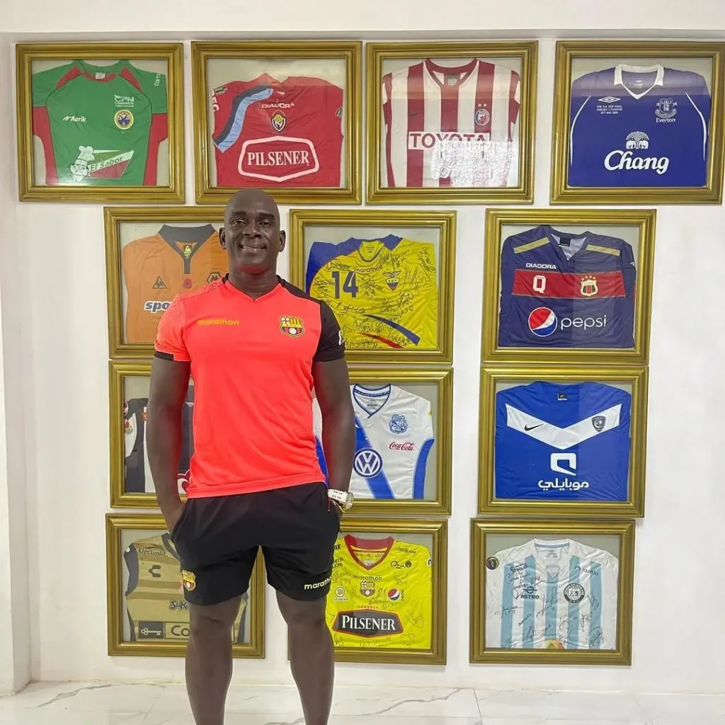 Junto a parte de su colección de camisetas.