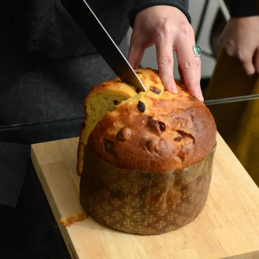 Una persona cortando una rebanada de pan de pascua.