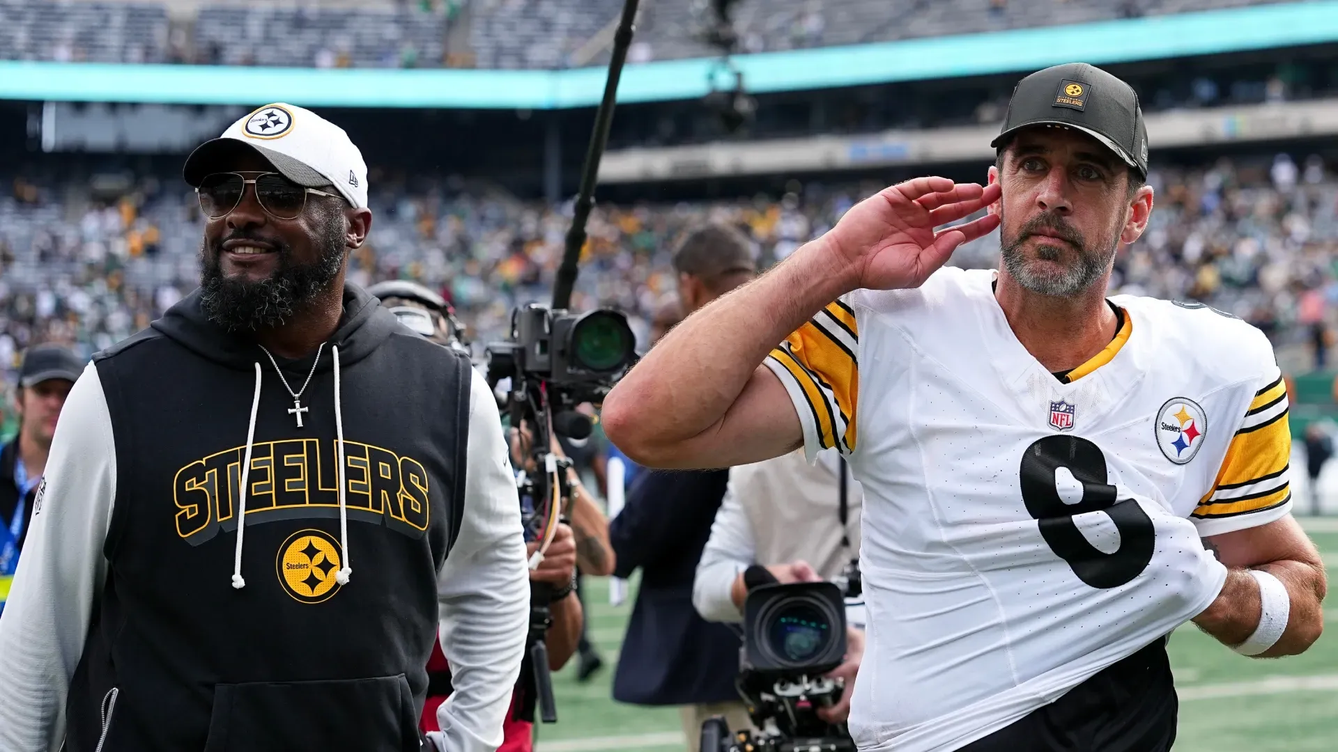 Mike Tomlin (left) and Aaron Rodgers after a win against the Jets.