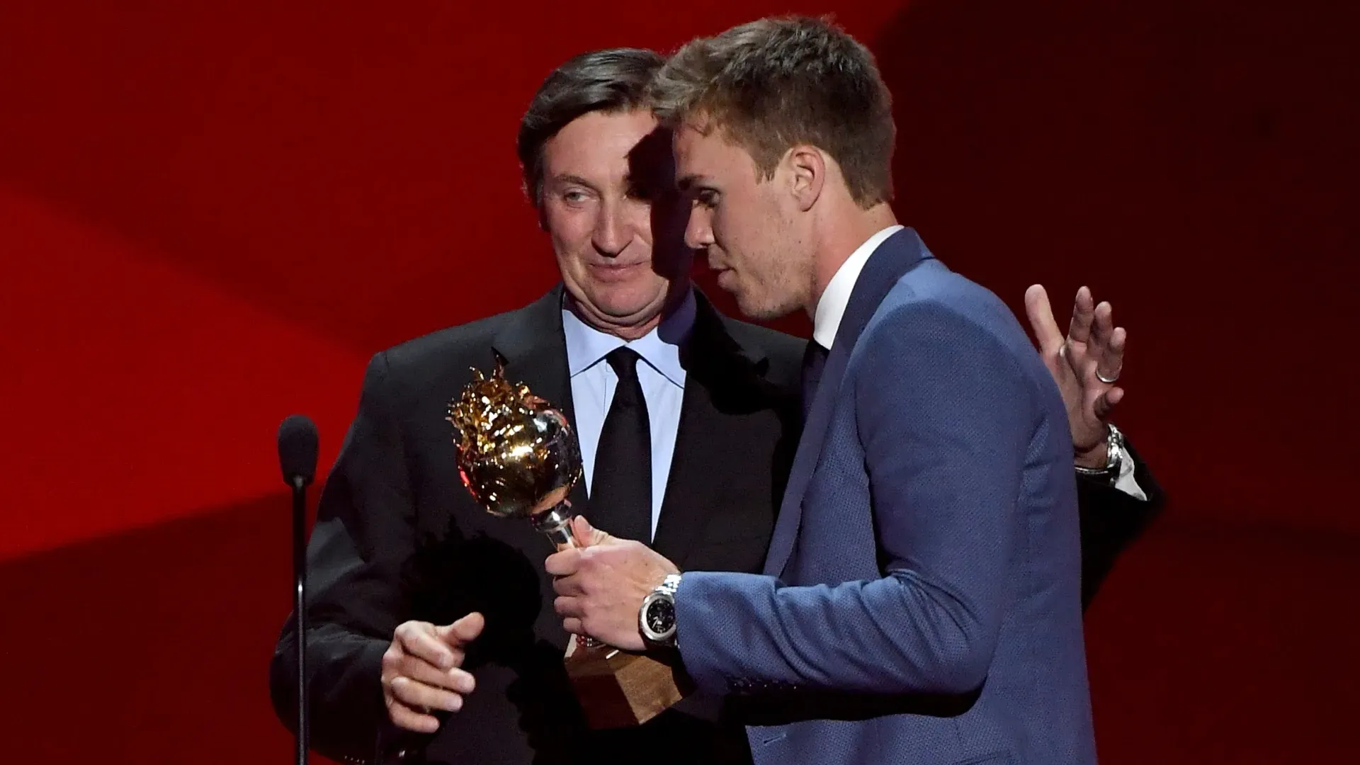 Connor McDavid of the Edmonton Oilers talks with Wayne Gretzky after McDavid wins the Hart Memorial Trophy. Ethan Miller/Getty Images