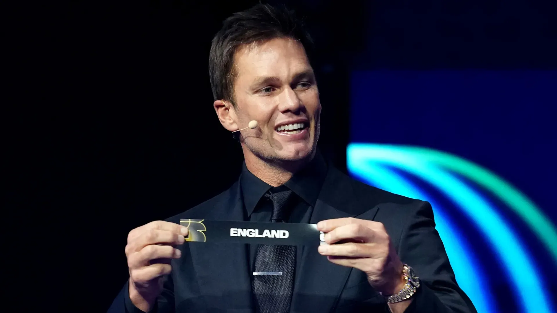 Draw assistant Tom Brady draws out the card of England during the FIFA World Cup 2026 Official Draw. Jia Haocheng – Pool/Getty Images