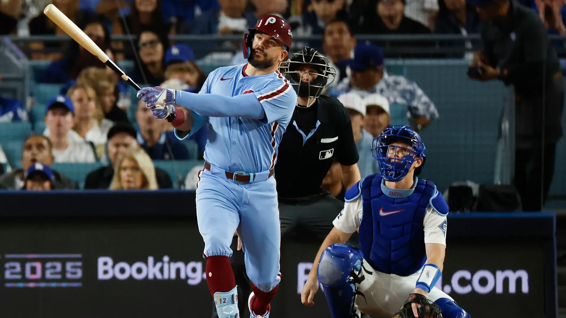 Kyle Schwarber #12 of the Phillies hits a solo home run against the Dodgers.  Harry How/Getty Images