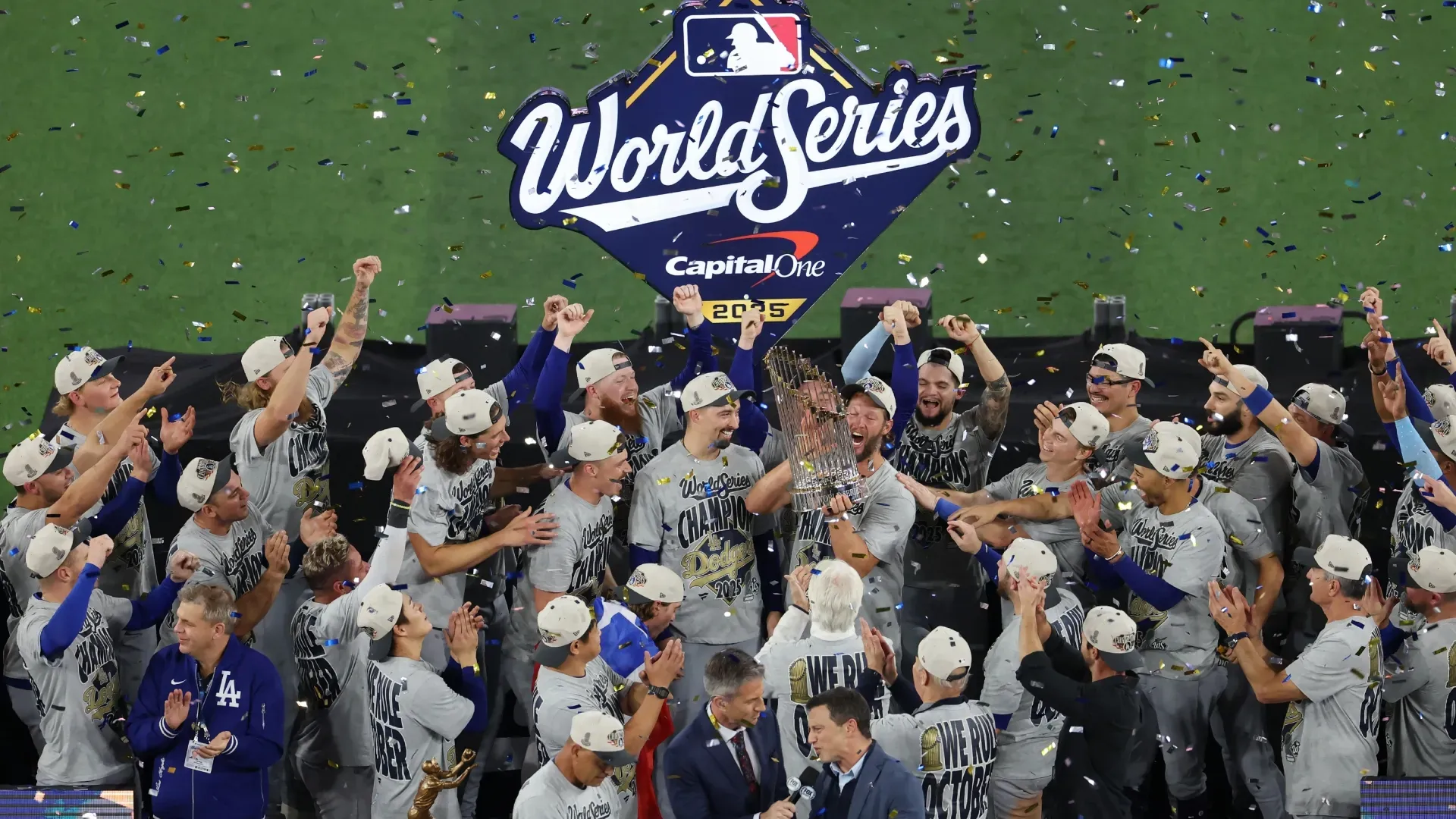 Clayton Kershaw #22 of the Los Angeles Dodgers raises the Commisioner’s Trophy. Mark Blinch/Getty Images