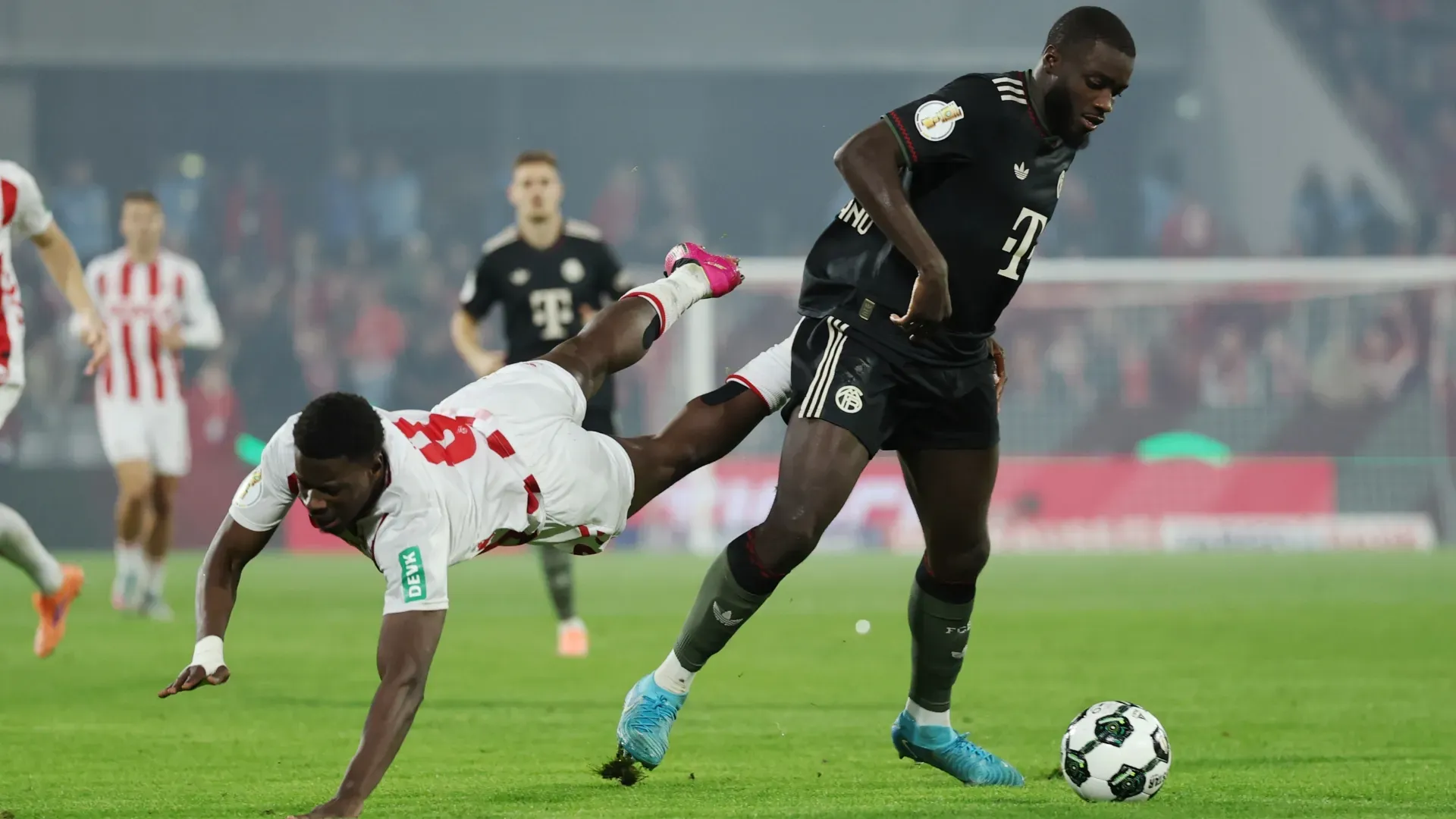 Ragnar Ache of 1. FC Koln and Dayot Upamecano of FC Bayern Munich