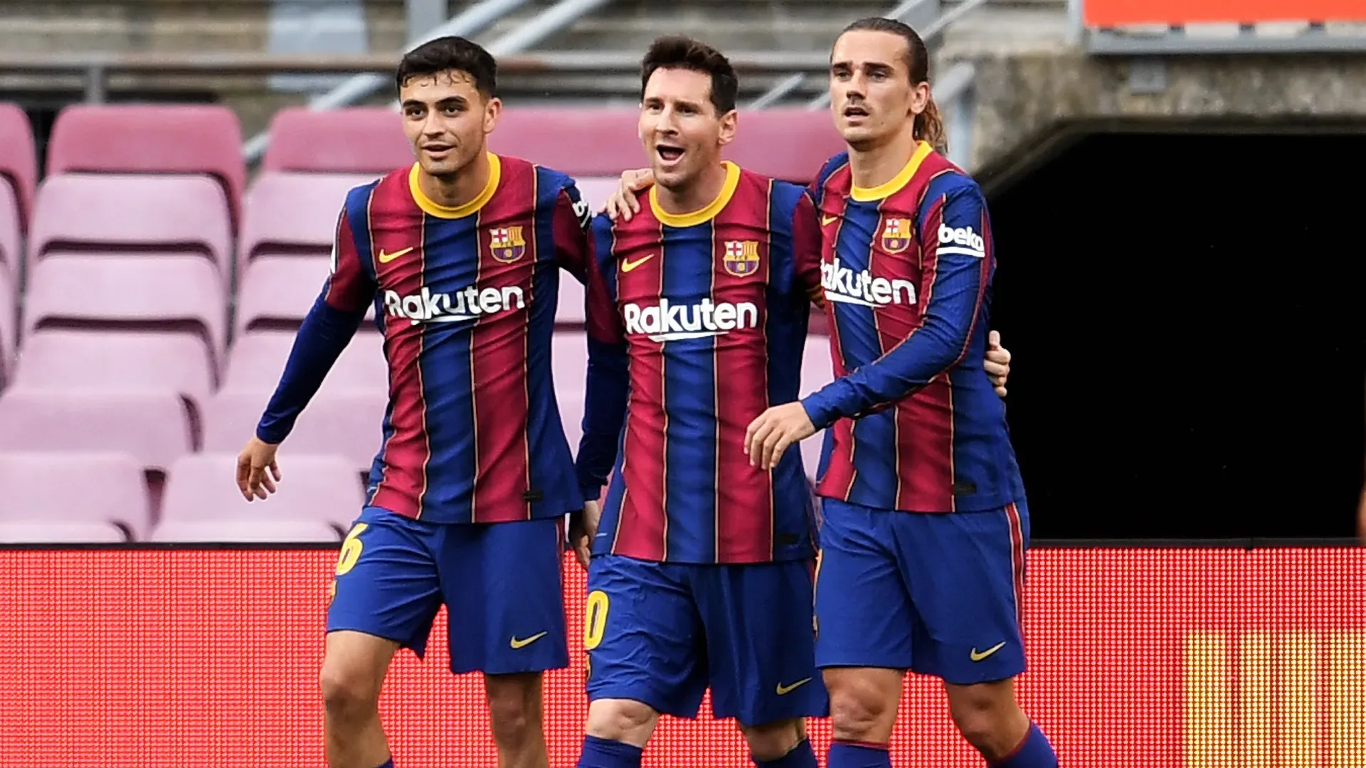 Lionel Messi celebrates with Pedri and Antoine Griezmann after scoring a goal for Barcelona.