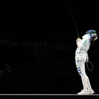 Why do fencers have a cable attached at the Paris 2024 Olympic Games?
