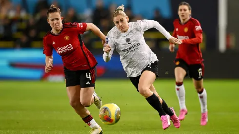 MANCHESTER, ENGLAND – JANUARY 24: Laura Coombs of Manchester City runs with the ball whilst under pressure from Maya Le Tissier of Manchester United during the FA Women's Continental Tyres League Cup match between Manchester City and Manchester United at Joie Stadium on January 24, 2024 in Manchester, England. (Photo by Gareth Copley/Getty Images)
