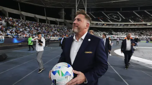 RIO DE JANEIRO, BRAZIL – FEBRUARY 27: President of CONMEBOL Alejandro Dominguez approaches the stands to girft a ball to fans prior to the Recopa Sudamericana 2025 Second Leg match between Botafogo and Racing Club at Estadio Olímpico Nilton Santos on February 27, 2025 in Rio de Janeiro, Brazil. (Photo by Wagner Meier/Getty Images)