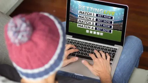 young man betting online . All screen graphics are made up.
