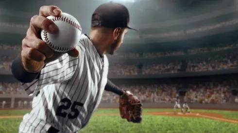 Baseball player throws the ball on professional baseball stadium
