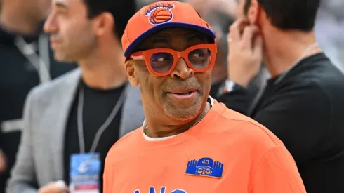 New York Knicks fan Spike Lee talks with other fans prior to a game.
