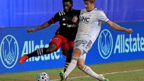 Chris Odoi-Atsem of DC United (left) and Justin Rennicks of New England Revolution fight for the ball (Getty).
