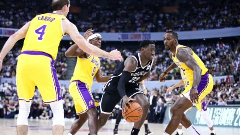 Alex Caruso, Rajon Rondo, and Dwight Howard guarding Nets' Caris LeVert. (Getty)
