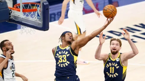 Myles Turner #33 of the Indiana Pacers reaches for the ball after Rudy Gobert #27 of the Utah Jazz misses the shot . (Getty)
