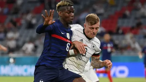 Paul Pogba and Toni Kroos fighting for the ball (Getty).
