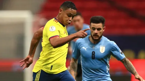 Luis Muriel of Colombia (left) and Nahitan Nández of Uruguay (Getty).