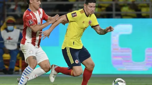 James Rodriguez of Colombia and Matias Rojas of Paraguay fight for the ball.
