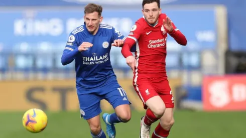 Marc Albrighton of Leicester (left) fights for ball possession against Andrew Robertson of Liverpool
