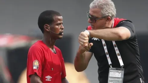 Tunisia head coach Mondher Kebaier points his watch to complain to Zambian referee Janny Sikazwe for ending the Mali vs Tunisia game prematurely.