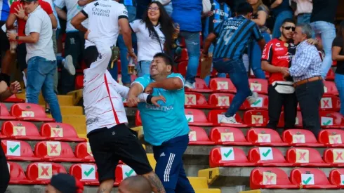 Fans of Atlas and Queretaro fight in the stands during the 9th round match between Queretaro and Atlas
