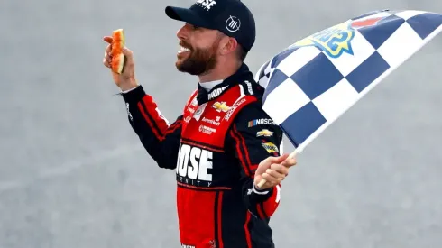 Chastain celebrates his victory at Talladega with a piece of watermelon he broke in his hand
