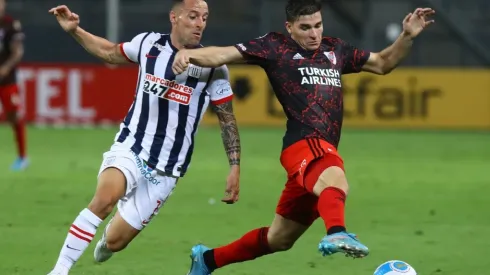 Julian Alvarez of River Plate fights for the ball with Pablo Lavandeira of Alianza Lima
