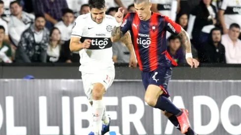 Ivan Torres of Olimpia competes for the ball with Alan Benitez of Cerro Porteño
