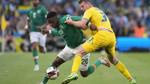 Chiedozie Ogbene of Republic of Ireland is tackled by Oleksandr Syrota of Ukraine
