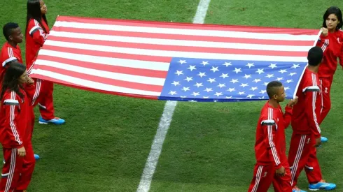 The United States flag is carried onto the field
