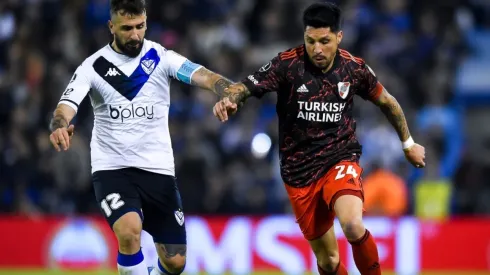 Lucas Pratto of Velez fights for the ball with Enzo Perez of River Plate
