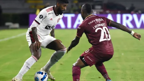 Rodinei of Flamengo fights for the ball Junior Hernández of Deportes Tolima