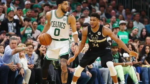 Jayson Tatum of the Boston Celtics handles the ball against Giannis Antetokounmpo of the Milwaukee Bucks
