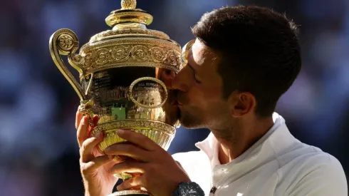 Novak Djokovic of Serbia kisses the Wimbledon trophy
