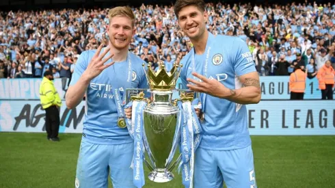 Kevin De Bruyne and John Stones of Manchester City celebrate with the Premier League trophy
