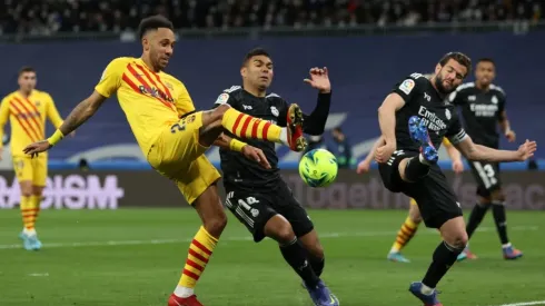 Pierre-Emerick Aubameyang of Barcelona battles for possession with Casemiro of Real Madrid
