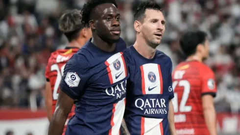 Arnaud Kalimuendo (L) of Paris Saint-Germain celebrates with Lionel Messi (R)
