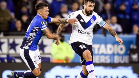 Lucas Pratto of Velez fights for the ball with Enzo Diaz of Talleres
