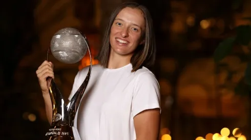 Iga Swiatek of Poland poses with the Chris Evert Trophy.
