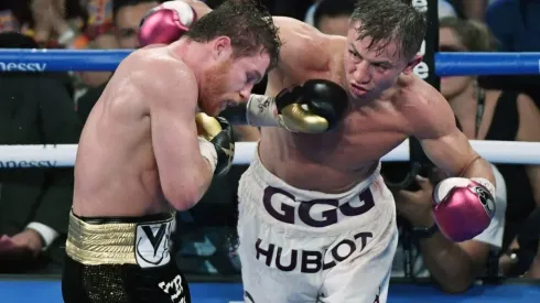 Gennady Golovkin (R) throws a right at Canelo Alvarez
