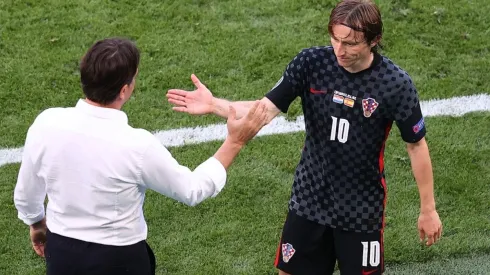 Luka Modric of Croatia shakes hands with coach Zlatko Dalic
