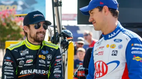 Ryan Blaney (L) and Joey Logano (R) talk on the grid