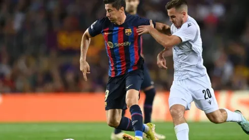 Robert Lewandowski of FC Barcelona battles for possession with Pavel Bucha of Viktoria Plzen
