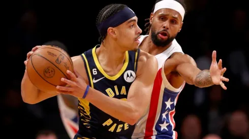 Andrew Nembhard of the Indiana Pacers tries to keep the ball from Patty Mills of the Brooklyn Nets
