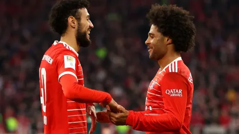 Serge Gnabry celebrates with Noussair Mazraoui of Bayern Munich
