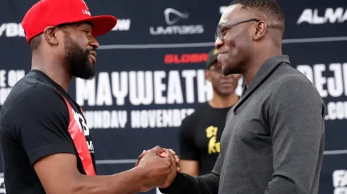 Floyd Mayweather Jr. (L) and Deji Olatunji (R) shake hands
