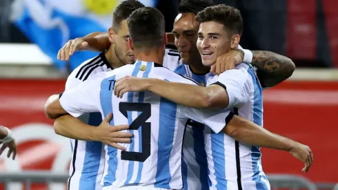 Julian Alvarez of Argentina is congratulated by teammates Nicolas Tagliafico,Giovani Lo Celso and Lautaro Martinez