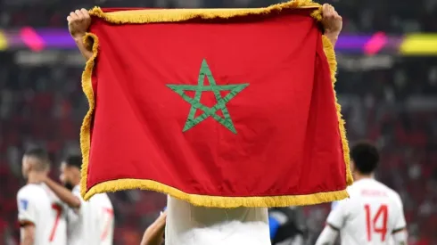 A player hold the national flag of Morocco
