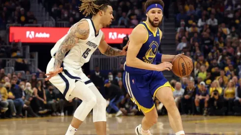 Klay Thompson of the Golden State Warriors dribbles the ball against Brandon Clarke of the Memphis Grizzlies
