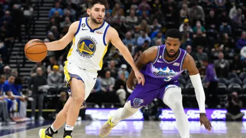 Ty Jerome of the Golden State Warriors drives past Malik Beasley of the Utah Jazz