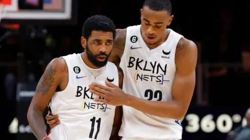 Kyrie Irving of the Brooklyn Nets reacts with Nic Claxton